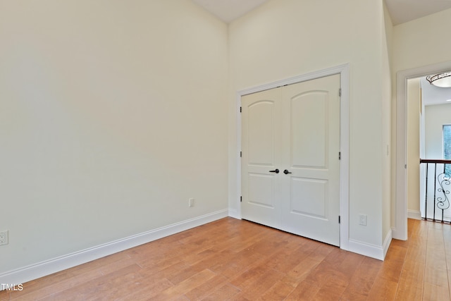 unfurnished bedroom featuring a closet and light hardwood / wood-style floors