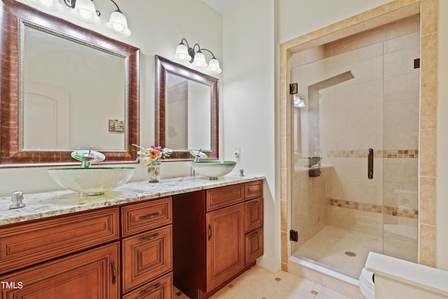 bathroom featuring tile patterned floors, walk in shower, vanity, and toilet