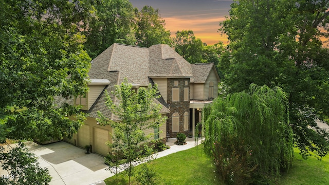 view of front of property with a lawn and a garage