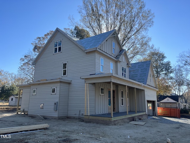 view of property exterior featuring a garage and covered porch