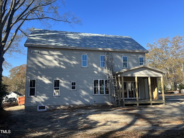 back of property with a porch