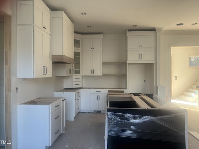 kitchen featuring concrete flooring and white cabinets