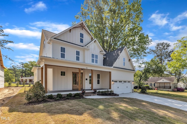 view of front facade with a porch, board and batten siding, driveway, and a front lawn