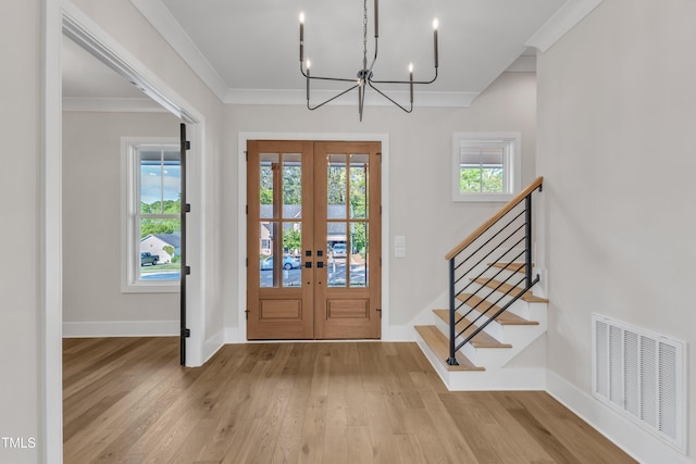 entryway featuring french doors, visible vents, an inviting chandelier, and a healthy amount of sunlight
