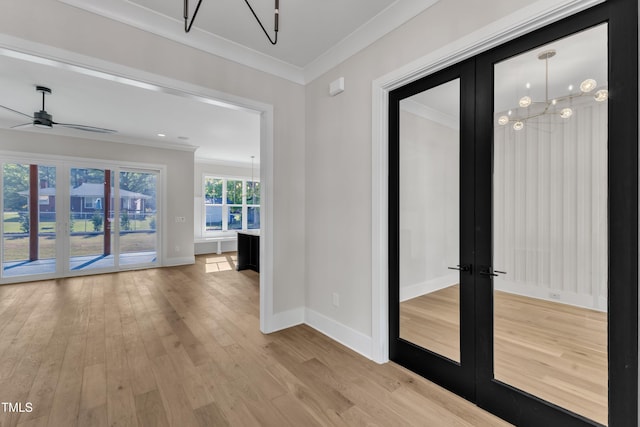 doorway to outside with crown molding, french doors, baseboards, and light wood-style floors