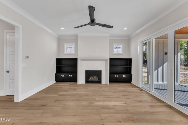 unfurnished living room with light wood-style floors, baseboards, a ceiling fan, and crown molding