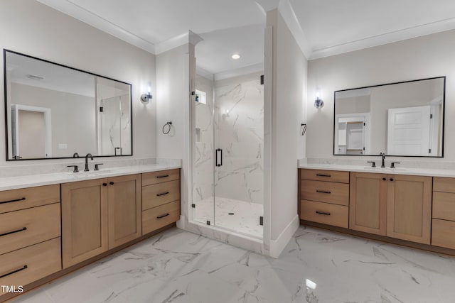 full bath featuring crown molding, two vanities, a marble finish shower, and a sink