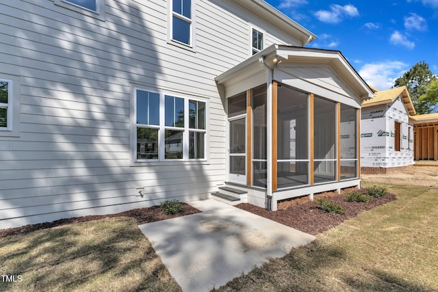 back of house with a sunroom
