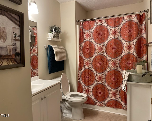 full bathroom with vanity, a textured ceiling, wood finished floors, and toilet