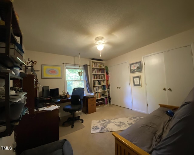 office area featuring ceiling fan and light carpet