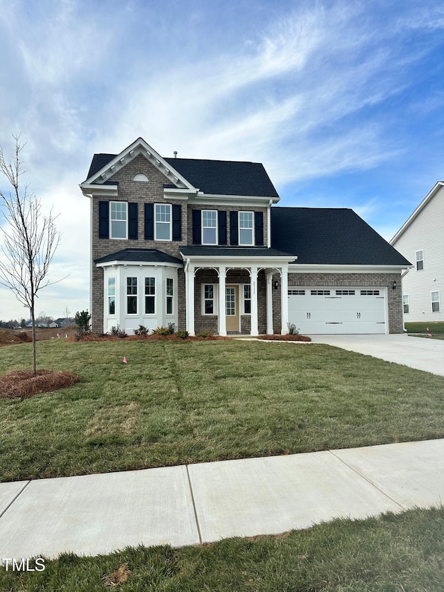 view of front of home featuring a garage and a front yard