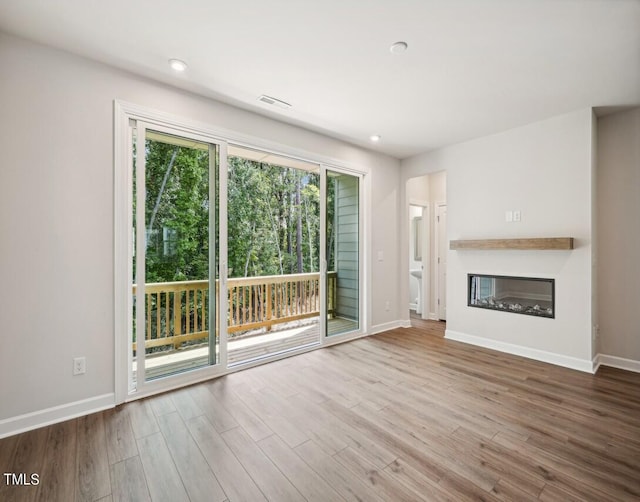 unfurnished living room with hardwood / wood-style floors