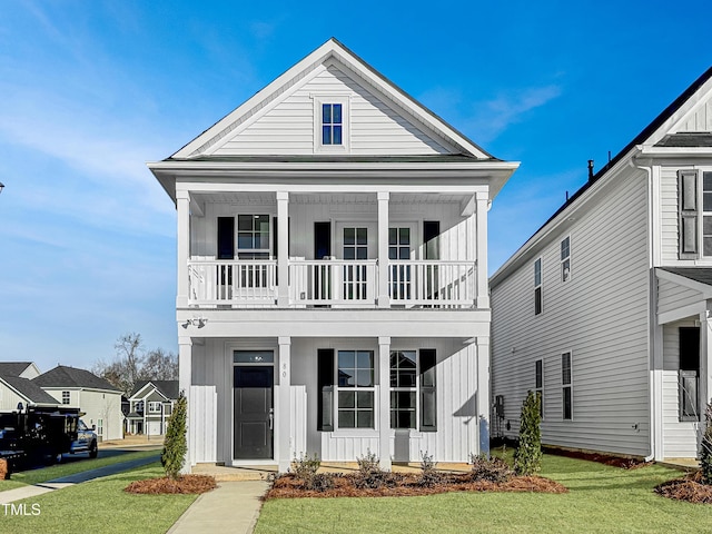 view of front of home featuring a front lawn and a balcony