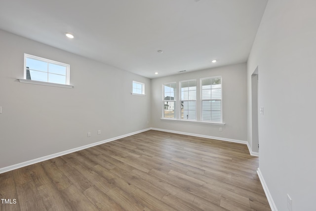 unfurnished room with light hardwood / wood-style floors