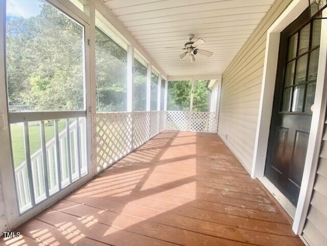 unfurnished sunroom with plenty of natural light and ceiling fan