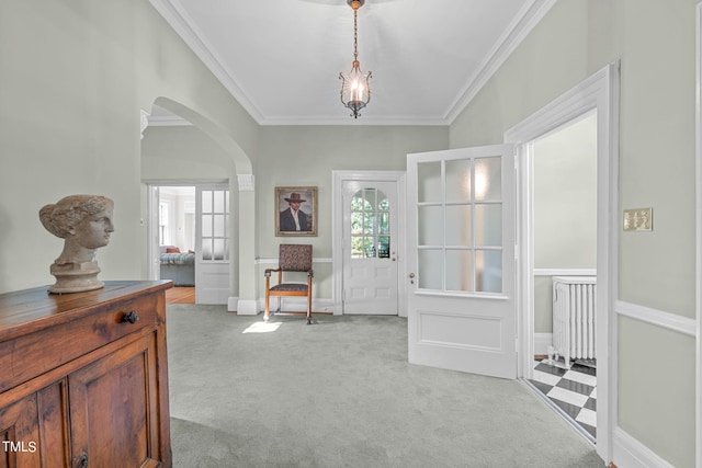 carpeted entryway featuring ornamental molding