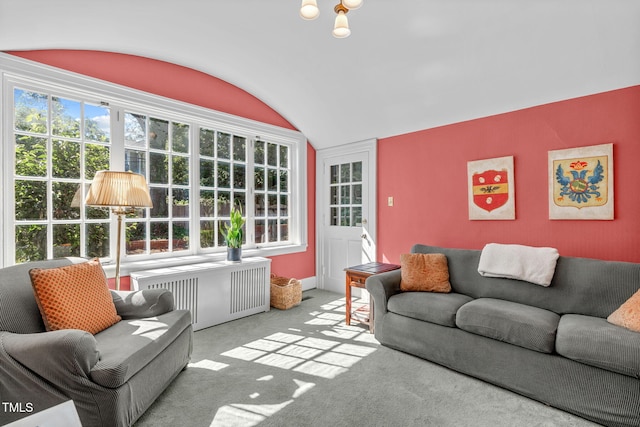 living room featuring a wealth of natural light, lofted ceiling, light colored carpet, and radiator