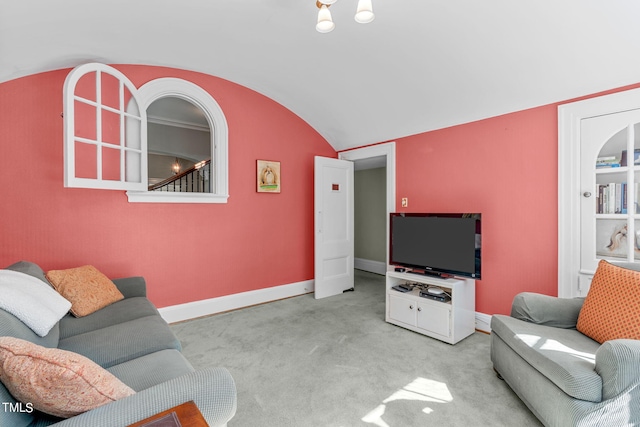 living room with lofted ceiling and light colored carpet