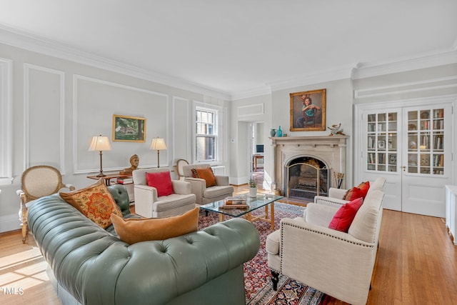 living room featuring ornamental molding and light hardwood / wood-style floors