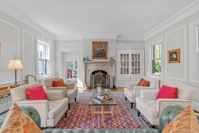 living room featuring hardwood / wood-style floors, crown molding, and plenty of natural light