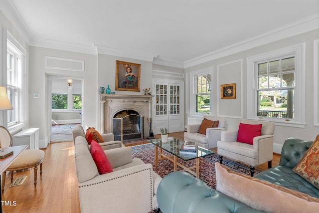 living room featuring crown molding and light hardwood / wood-style flooring