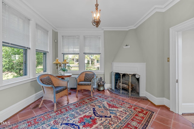 living area with radiator, tile patterned floors, ornamental molding, and a fireplace