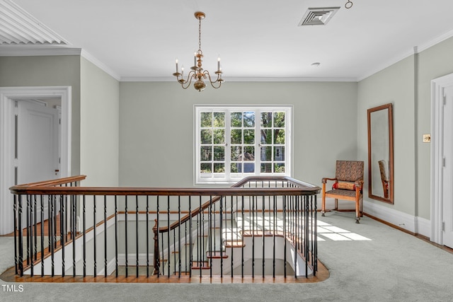 corridor with crown molding, light colored carpet, and a chandelier