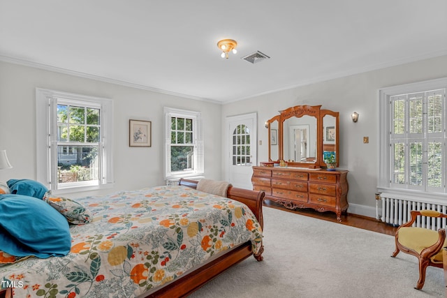 bedroom featuring ornamental molding, hardwood / wood-style floors, and radiator