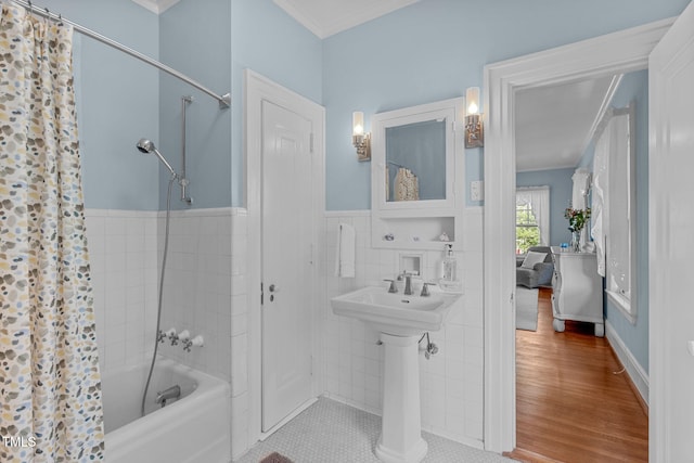 bathroom featuring tile walls, ornamental molding, hardwood / wood-style floors, and shower / bath combination with curtain