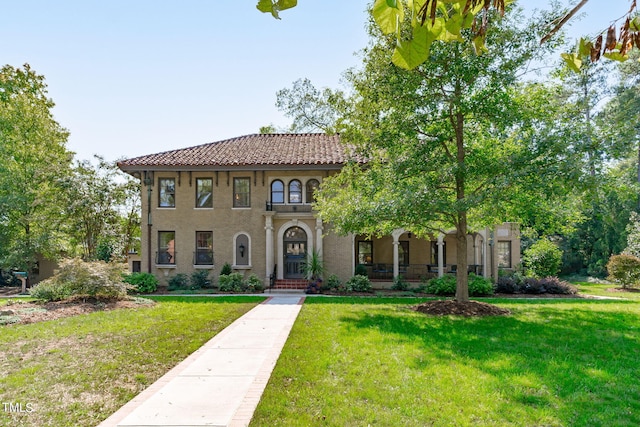 mediterranean / spanish home with a front yard