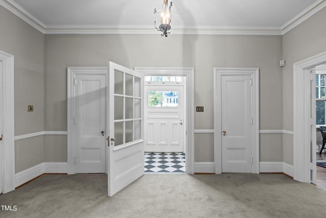 carpeted entrance foyer with crown molding and a healthy amount of sunlight