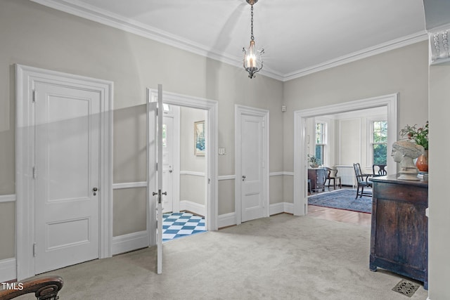 foyer featuring crown molding and light colored carpet