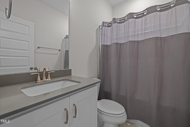 bathroom featuring walk in shower, vanity, and toilet