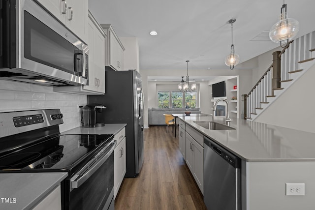 kitchen featuring white cabinets, stainless steel appliances, and sink