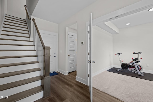 stairway featuring wood-type flooring