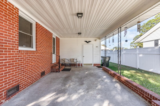 view of patio / terrace featuring fence, visible vents, and entry steps