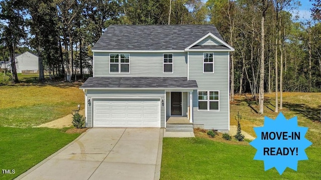 view of property with a front lawn and a garage