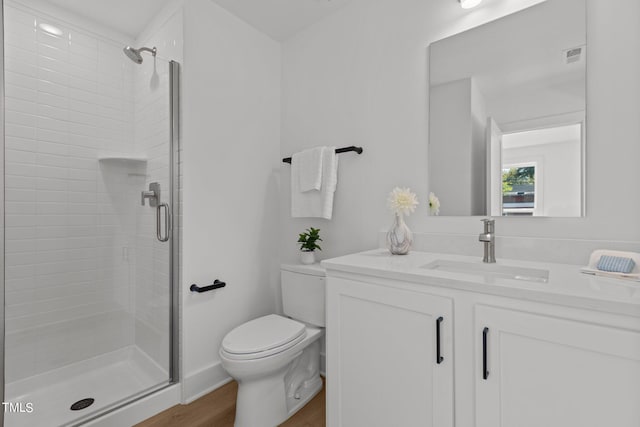 bathroom with toilet, an enclosed shower, vanity, and hardwood / wood-style floors