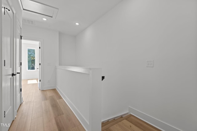 hallway with light hardwood / wood-style flooring