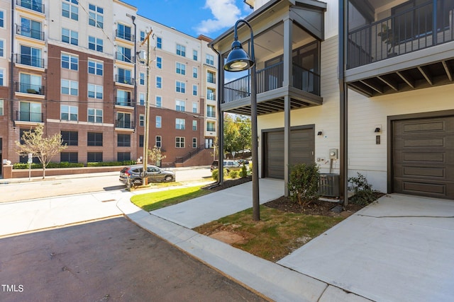 view of property featuring central AC unit and a garage