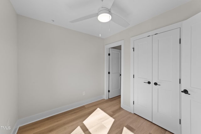 bedroom featuring ceiling fan, light hardwood / wood-style flooring, and a closet