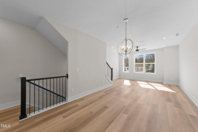 unfurnished dining area with light hardwood / wood-style flooring and a chandelier