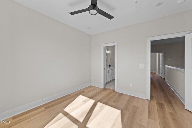 unfurnished bedroom with ceiling fan, light hardwood / wood-style flooring, and connected bathroom