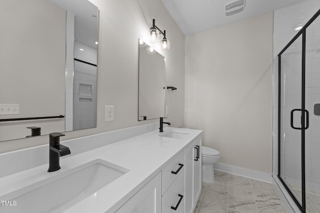 bathroom with toilet, vanity, and an enclosed shower