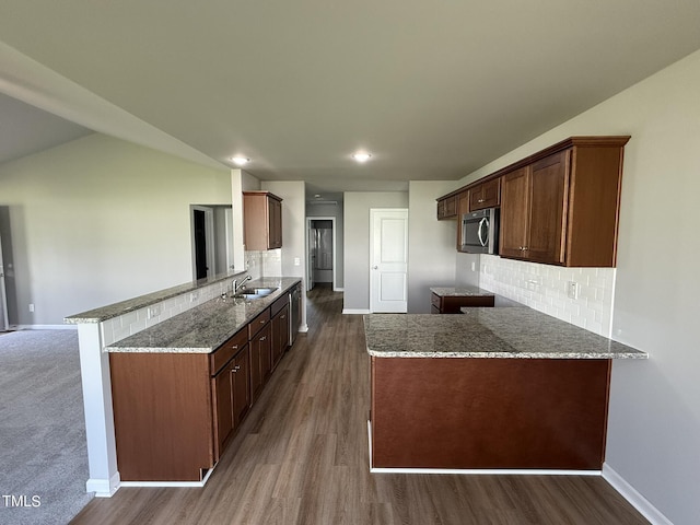 95 Grace Ridge Ct, Benson, NC 27504 - kitchen featuring baseboards, a peninsula, stainless steel microwave, and a sink