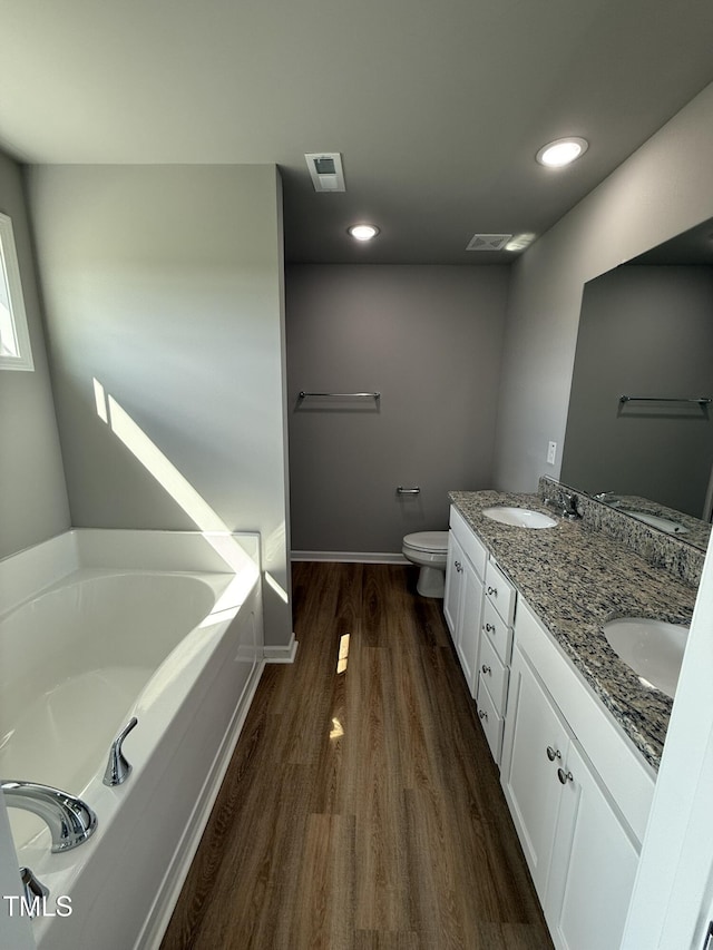 95 Grace Ridge Ct, Benson, NC 27504 - full bath with a garden tub, visible vents, wood finished floors, toilet, and a sink