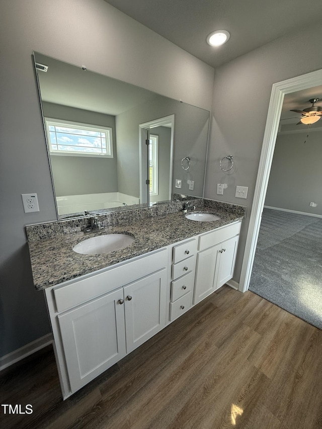 95 Grace Ridge Ct, Benson, NC 27504 - bathroom with baseboards, a sink, and wood finished floors