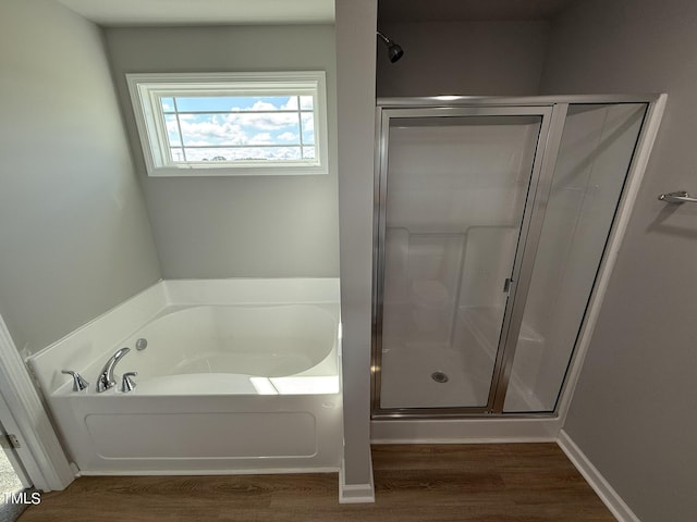 95 Grace Ridge Ct, Benson, NC 27504 - bathroom with wood finished floors, a bath, and a stall shower