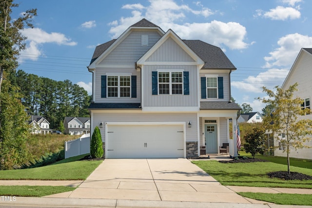 craftsman house featuring a front yard and a garage