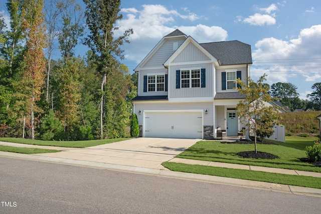 craftsman house featuring a front yard and a garage